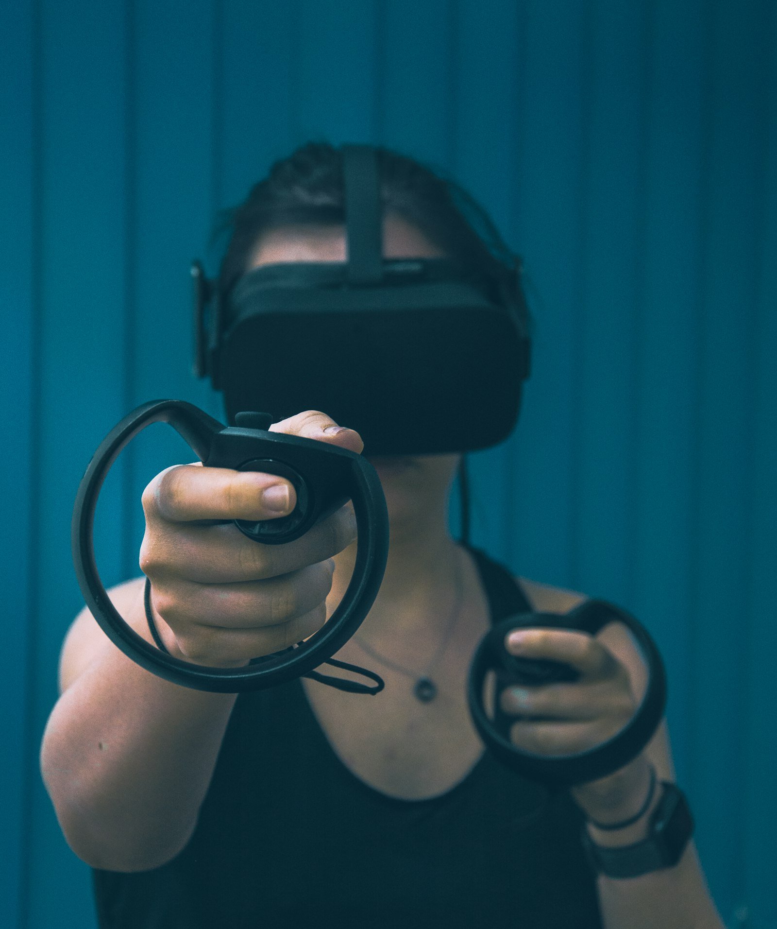 Hands interacting with a haptic glove controlling a virtual scenario